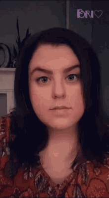a woman 's face is shown in front of a sign that says ' bri '