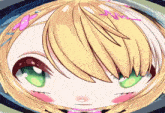 a close up of a girl 's face with green eyes and blonde hair