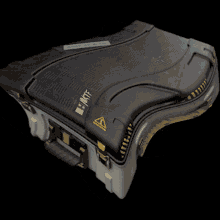 a black item with a yellow triangle on it that says " warning "