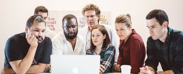 People at a table stoked on a project